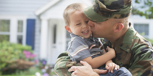 veteran embracing child
